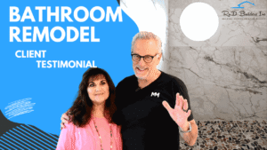 Promotional graphic for a bathroom remodel client testimonial video featuring two satisfied clients standing in front of a marble-tiled shower by RnD Builders Inc