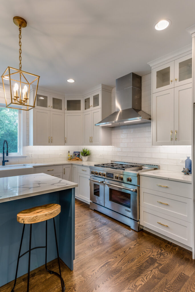 White Shaker Kitchen with Teal Island in Calabasas Calabasas kitchen remodel: White shaker kitchen with teal island, quartz countertops, and stainless pro range in Calabasas by RnD Builders Inc