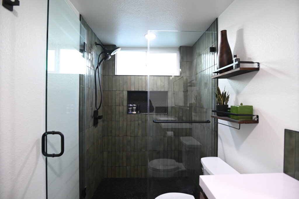 Simi Valley Home Remodel Simi Valley home remodel: Modern industrial bathroom with dark green vertical tile shower and frameless glass door in Simi Valley by RnD Builders Inc
