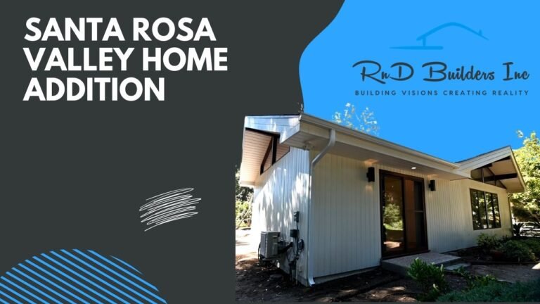 Exterior home addition with white vertical board siding, low-pitch roof, and dark-framed sliding glass door by RnD Builders Inc