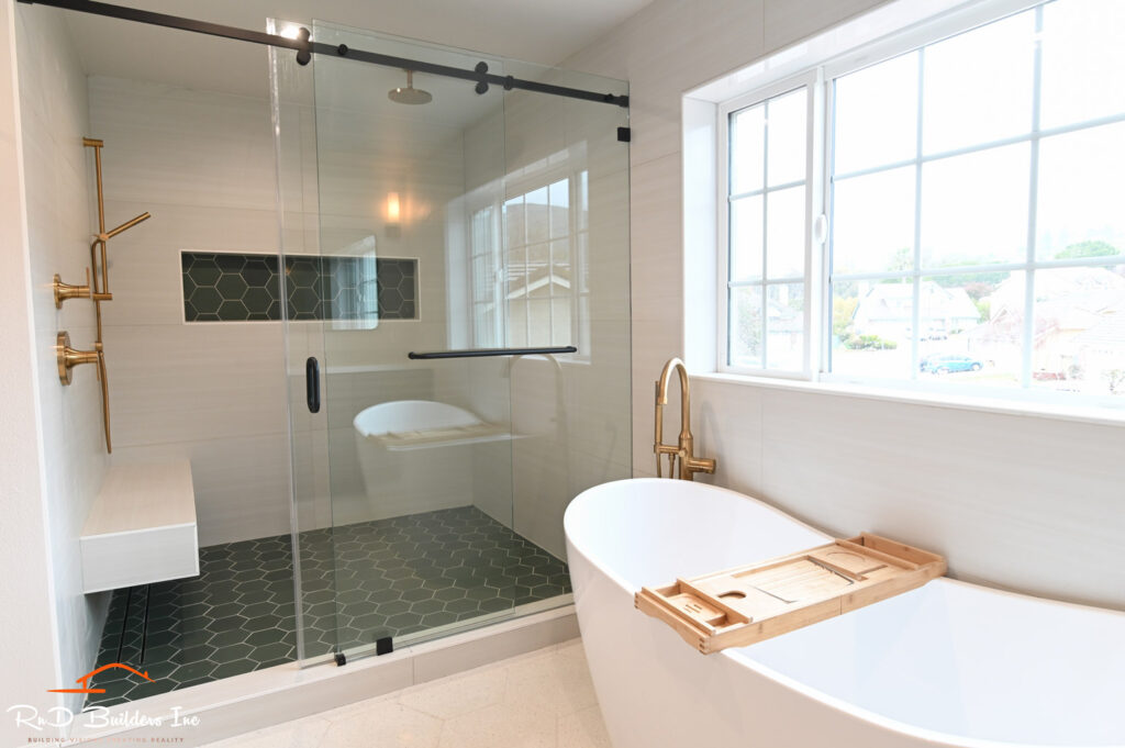 Luxury Master Bathroom with Freestanding Soaking Tub Newbury Park home remodel: Luxury master bathroom with freestanding soaking tub, frameless sliding glass shower, and dark hexagon tile floor in Newbury Park by RnD Builders Inc