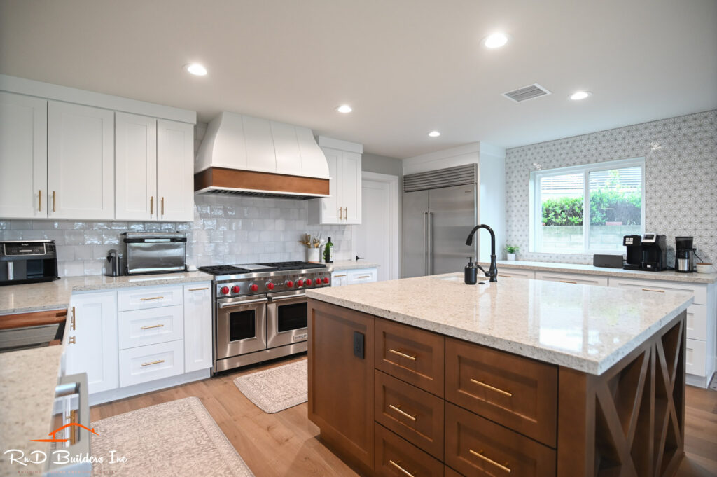 Transitional Kitchen Remodel with White Shaker Cabinets Newbury Park home remodel: Transitional kitchen remodel with white shaker cabinets, walnut island, and Wolf dual-fuel range in Newbury Park by RnD Builders Inc