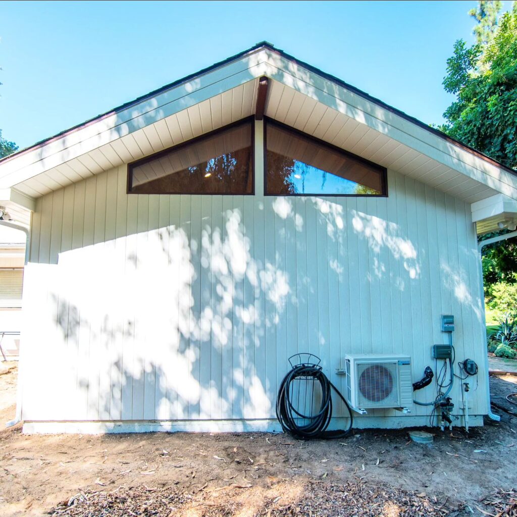 Exterior of a Mid-century Modern ADU Exterior of a mid-century modern ADU with vertical board siding and clerestory windows by RnD Builders Inc