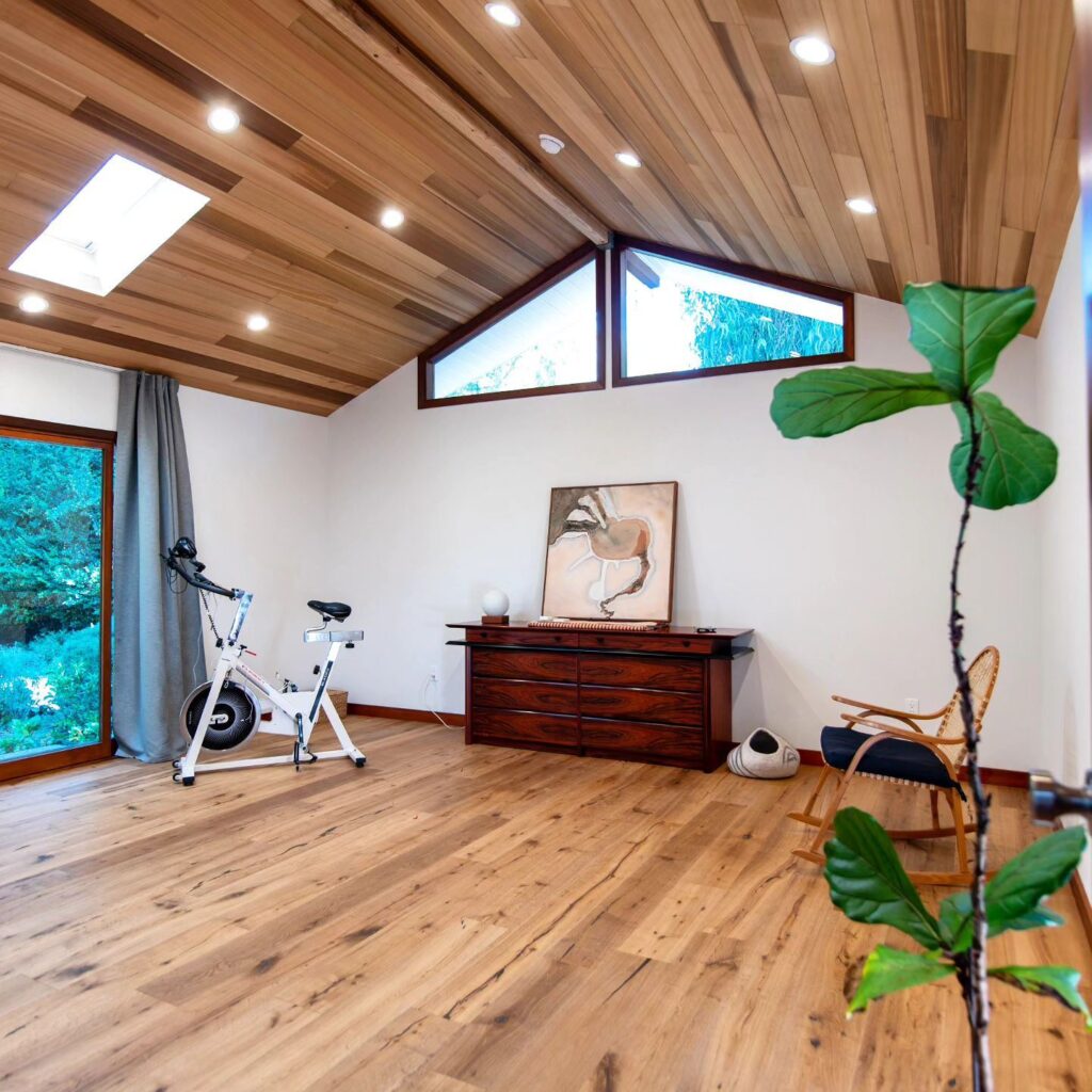 Vaulted Wood-clad Ceiling Room with Hardwood Floors
