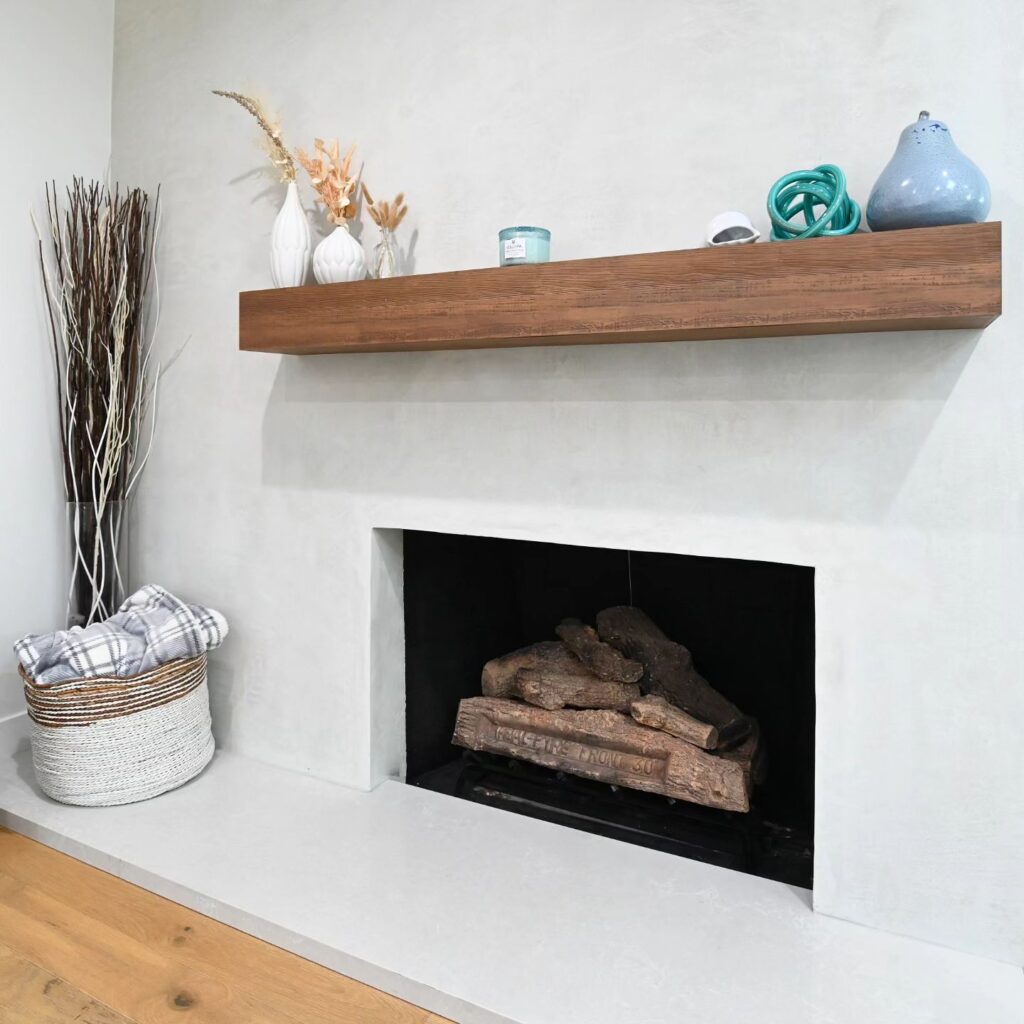 Modern Plaster Fireplace Surround Modern plaster fireplace surround with floating wood mantel and gas log insert by RnD Builders Inc