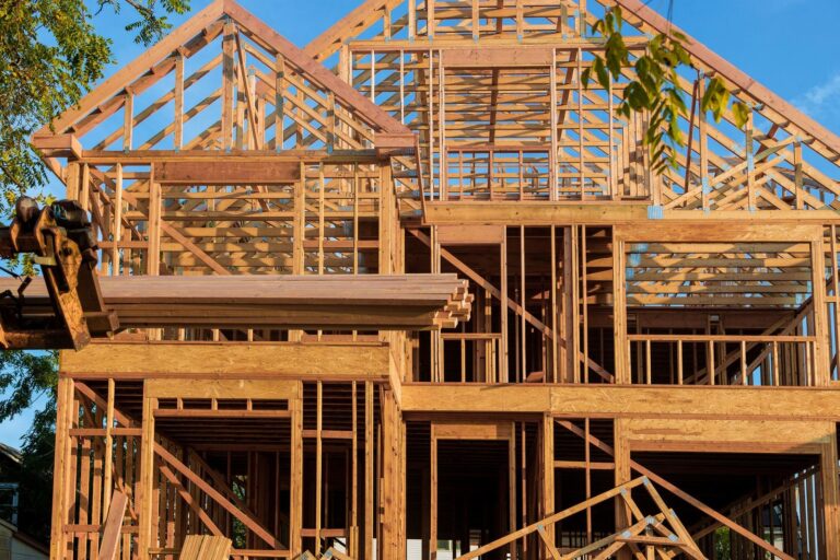 Exterior of a house under construction, showing wooden framing and support beams. Home framing construction by RnD Builders