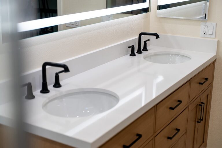 Agoura Hills bathroom remodel: Double undermount sink bathroom vanity with white quartz countertop and matte black faucets in Agoura Hills by RnD Builders Inc