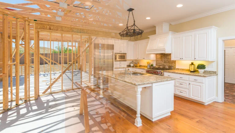 Before-and-after composite showing wood framing transitioning to finished white kitchen with granite island by RnD Builders Inc