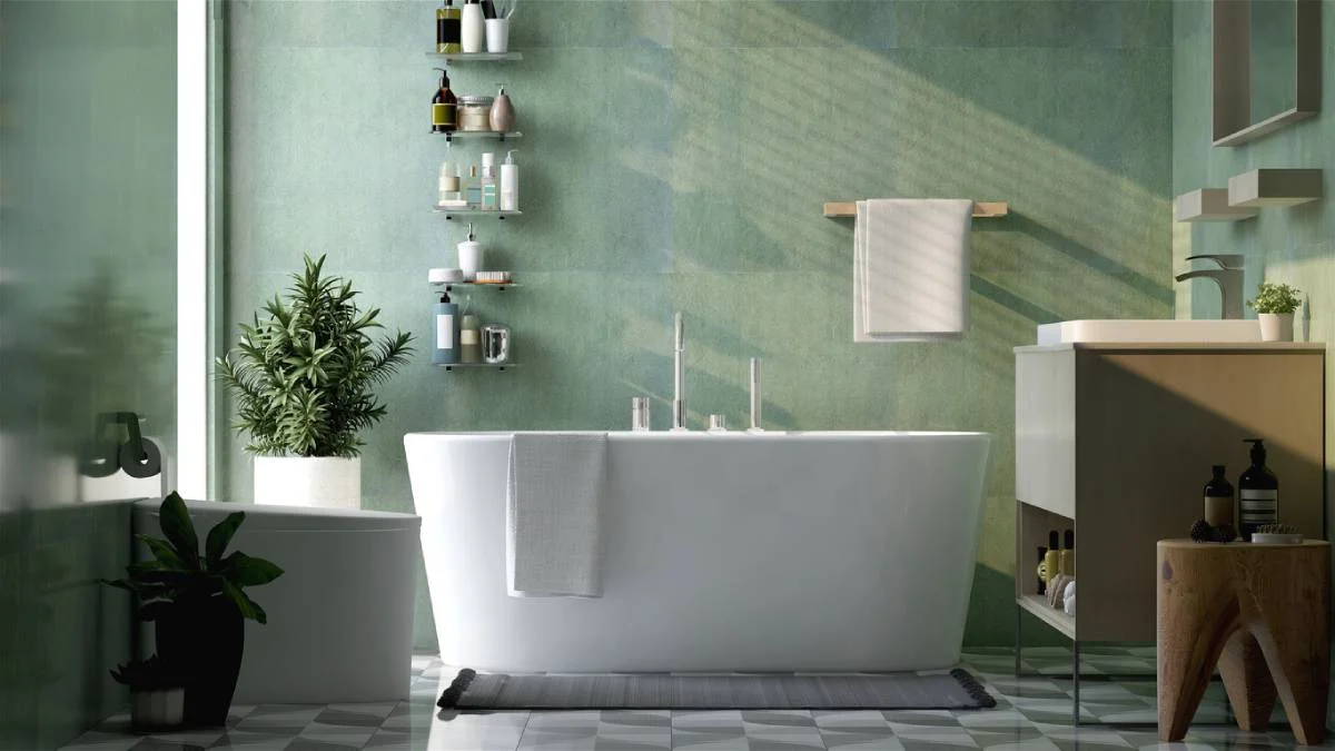 Spa-style bathroom with white freestanding soaking tub, sage green walls, and geometric floor tile by RnD Builders Inc