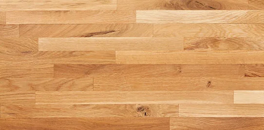 Close-up of natural oak hardwood flooring with visible wood grain and knots by RnD Builders Inc