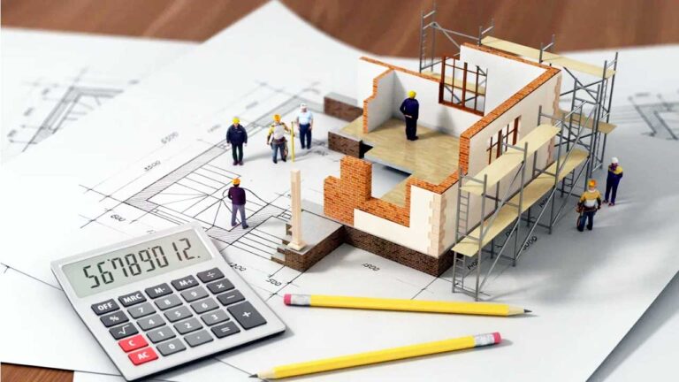 builder calculating home construction cost on blueprint
