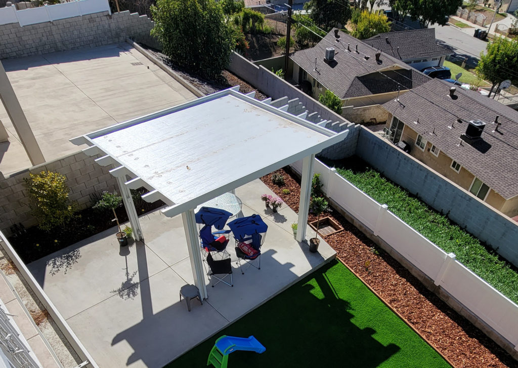 Aerial View of White Aluminum Patio Cover over Concrete Aerial view of white aluminum patio cover over concrete slab backyard with artificial turf by RnD Builders Inc