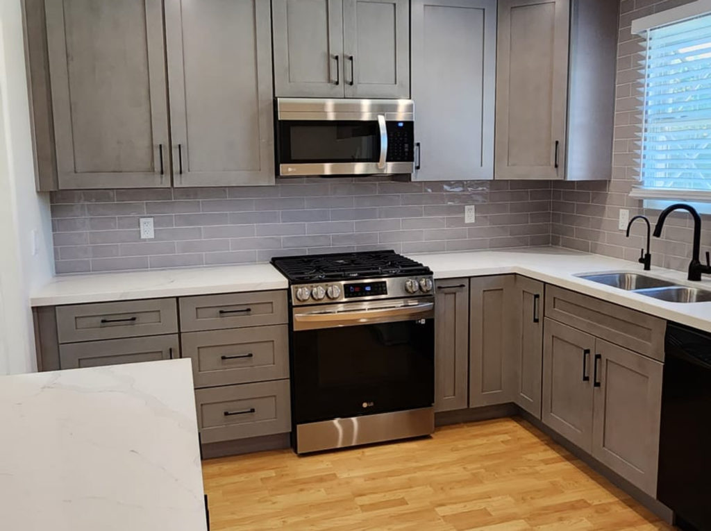 Torrance kitchen remodel: Gray shaker cabinet kitchen with white quartz countertops and stainless steel LG appliances in Torrance by RnD Builders Inc