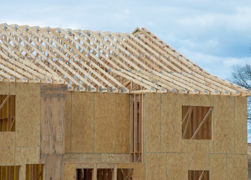 installation of rafters of a plywood house building wall studs wooden frame rooftop