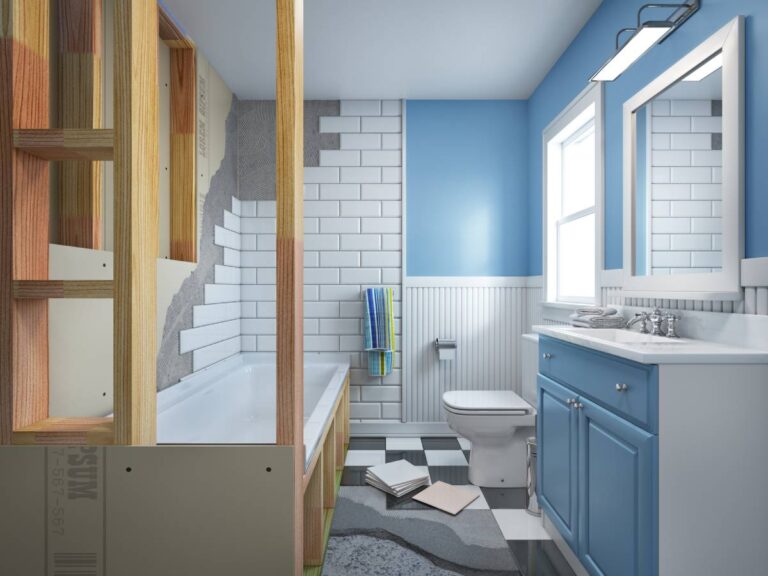 A bathroom featuring blue cabinets and a white toilet, showcasing a modern and clean design.