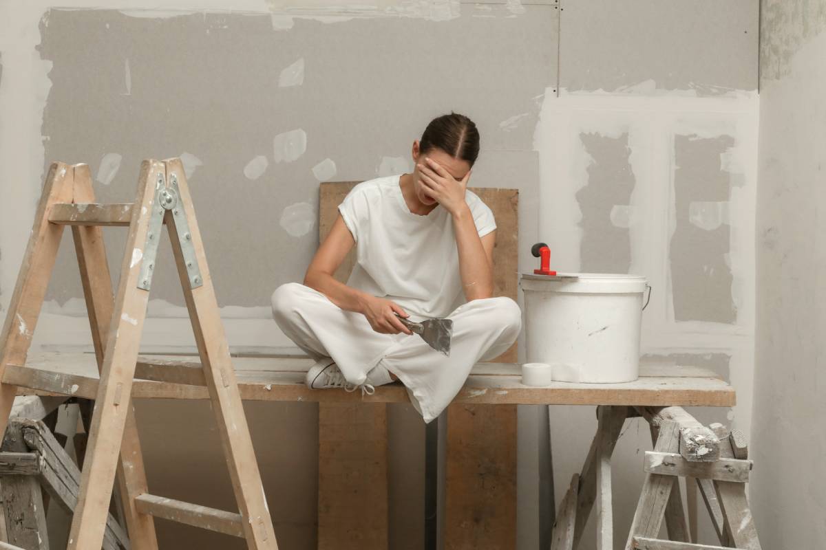 Tired and frustrated women resting during home renovation.