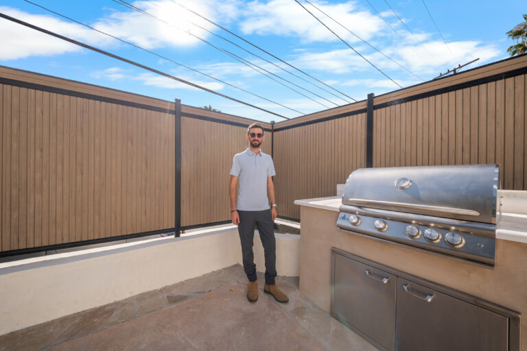 Outdoor Grill Station Along Privacy Fence with a stainless steel built-in grill, storage doors and a composite fence in Manhattan Beach by RnD Builders Inc