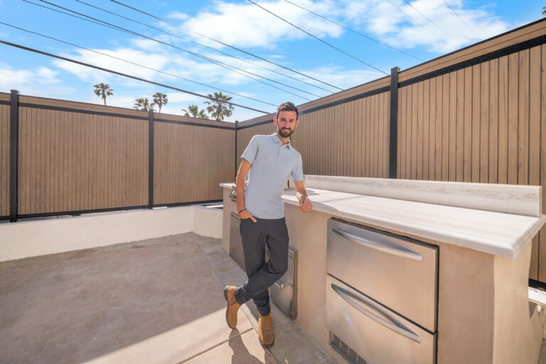 Outdoor Kitchen Counter with Stainless Drawers with a built-in counter, stainless steel drawers and a wood-look fence in Manhattan Beach by RnD Builders Inc