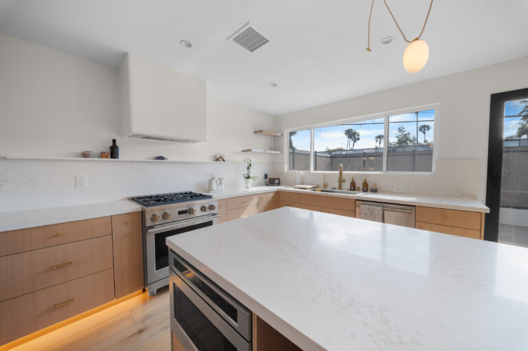 Kitchen Range Wall and Island Corner with a stainless range, open shelves and a quartz island in Manhattan Beach by RnD Builders Inc
