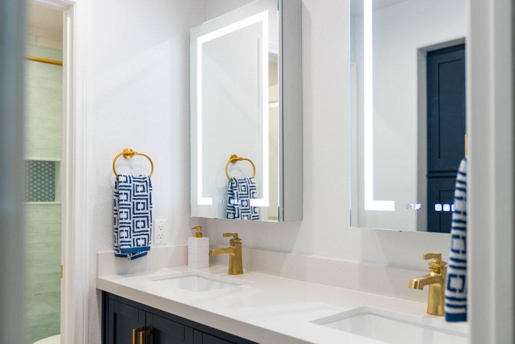 Home remodeling contractor in Oxnard: double-sink bathroom remodel with LED mirrors by RnD Builders