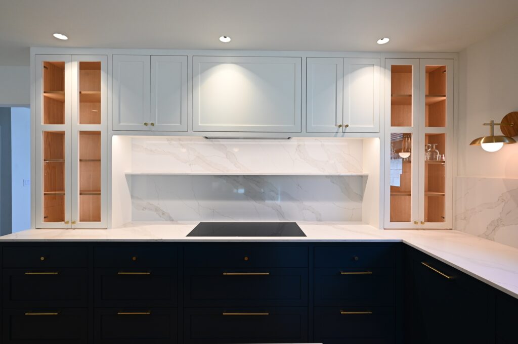 Los Angeles custom kitchen: Two-tone kitchen with navy blue lower cabinets, light blue uppers, marble backsplash, and induction cooktop in Los Angeles by RnD Builders Inc