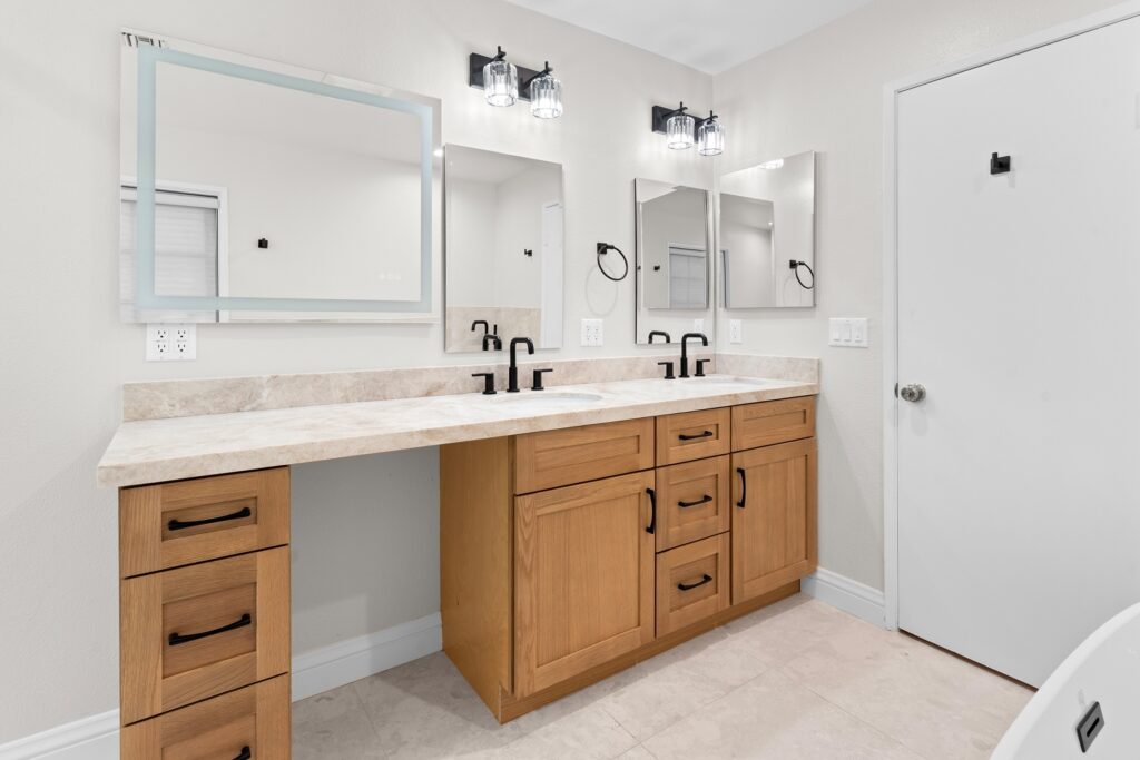 Master Bathroom Double Vanity with Honey Oak Cabinets in Thousand Oaks Thousand Oaks full remodel: Master bathroom double vanity with honey oak cabinets, marble countertop, and matte black fixtures in Thousand Oaks by RnD Builders Inc