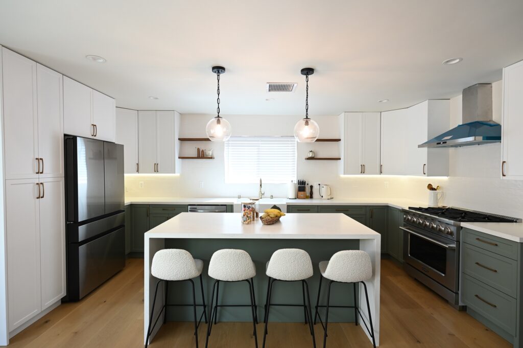 Modern Kitchen with Sage Green Lower Cabinets West Hills full remodel: Modern kitchen with sage green lower cabinets, white uppers, quartz island, and boucle barstools in West Hills by RnD Builders Inc