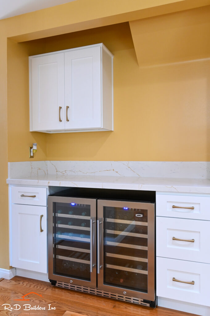 Built-in wine bar with dual wine coolers, white shaker cabinets, and quartz countertop in Manhattan Beach by RnD Builders Inc