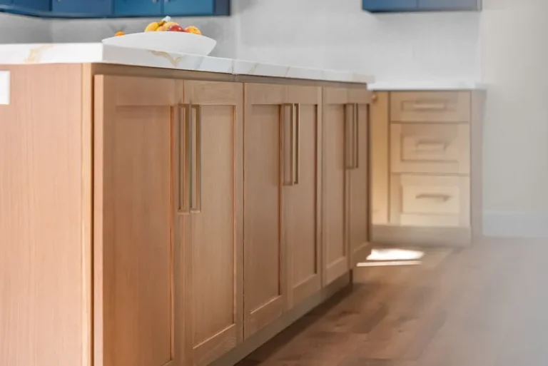 Natural wood shaker kitchen island with white quartz countertop and brushed gold hardware in Thousand Oaks by RnD Builders Inc