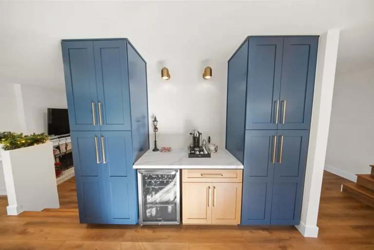 Built-in blue shaker cabinet wet bar with marble countertop and wine fridge in Thousand Oaks by RnD Builders Inc