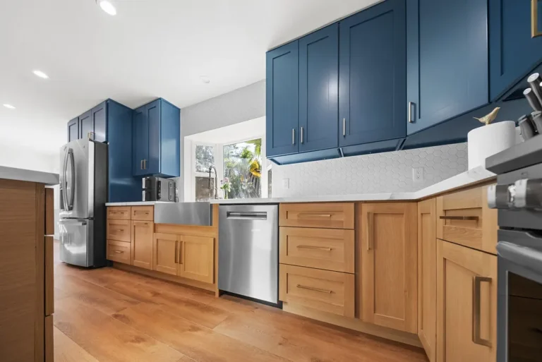 Two-tone kitchen with navy blue upper cabinets and natural wood lower cabinets in Thousand Oaks by RnD Builders Inc