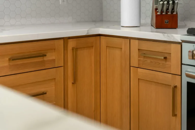 Warm oak shaker-style base cabinets with brass pulls and white quartz countertop in Thousand Oaks by RnD Builders Inc