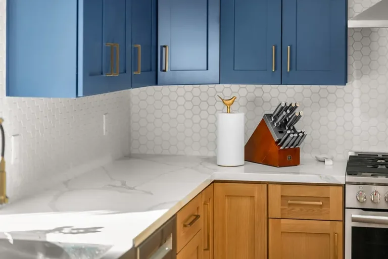 Thousand Oaks home transformation: Two-tone kitchen with blue upper cabinets, natural wood lower cabinets, and white marble quartz countertops in Thousand Oaks by RnD Builders Inc