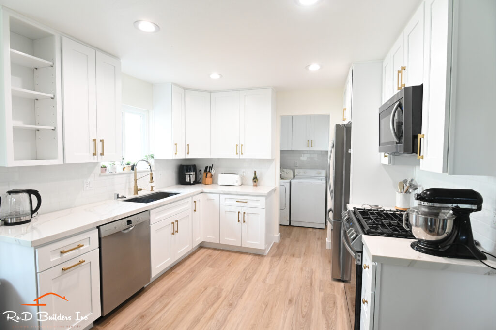 Bright white shaker cabinet kitchen remodel with gold hardware and stainless steel appliances in Thousand Oaks by RnD Builders Inc
