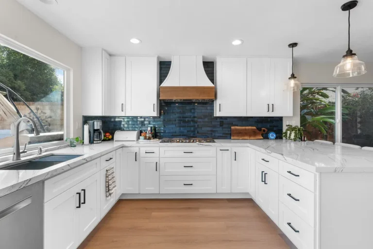 White shaker kitchen with navy blue subway tile backsplash and quartz countertops in Moorpark by RnD Builders Inc