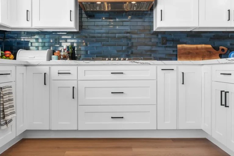 White shaker kitchen cabinets with blue subway tile backsplash and quartz countertops in Moorpark by RnD Builders Inc