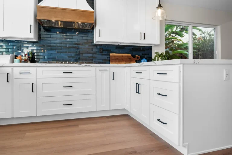 White shaker kitchen cabinets with blue subway tile backsplash and marble countertops in Moorpark by RnD Builders Inc