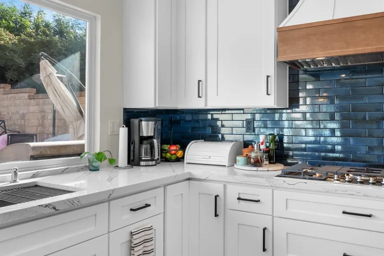 White shaker kitchen with blue subway tile backsplash and quartz countertops in Moorpark by RnD Builders Inc