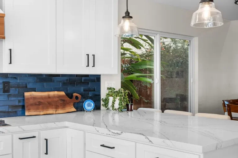 White shaker kitchen with navy blue subway tile backsplash and white marble quartz countertop in Moorpark by RnD Builders Inc