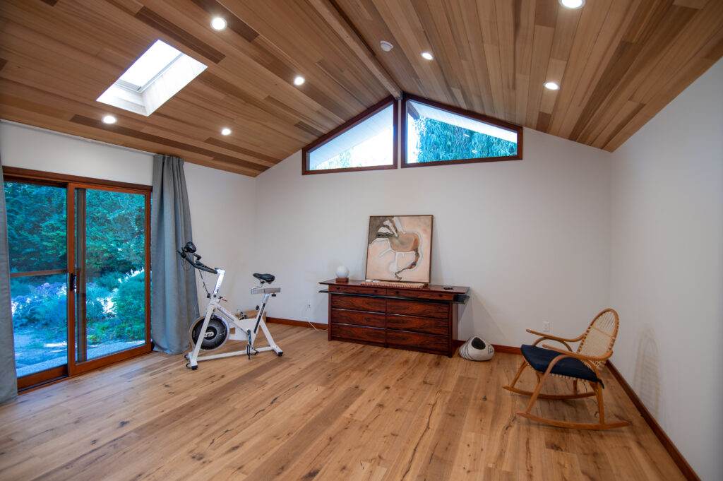 Vaulted Wood-plank Ceiling Room with Skylight in Santa Rosa Valley Vaulted wood-plank ceiling room with skylight, hardwood floors, and sliding glass door in Santa Rosa Valley by RnD Builders Inc