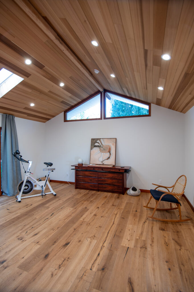 Vaulted Wood-plank Ceiling Room with Wide-plank Oak Floors in Santa Rosa Valley Vaulted wood-plank ceiling room with wide-plank oak floors, clerestory windows, and rocking chair in Santa Rosa Valley by RnD Builders Inc
