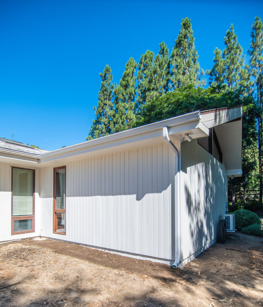 Exterior Residential Room Addition in Santa Rosa Valley Exterior residential room addition with white vertical board and batten cladding and white guttering in Santa Rosa Valley by RnD Builders Inc