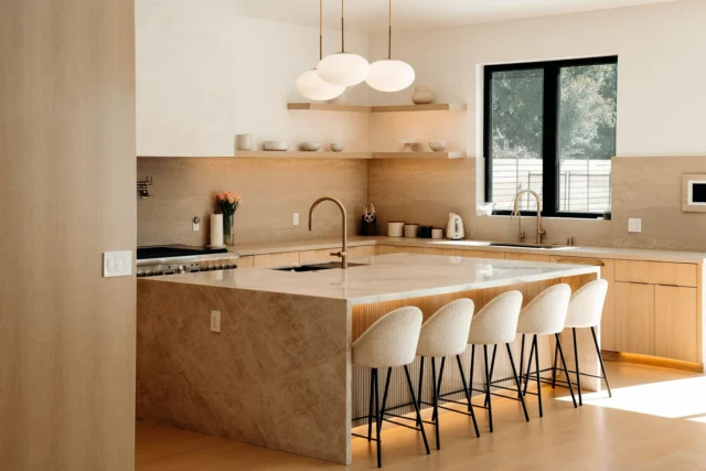 Warm Modern Kitchen with Stone Waterfall Island in Woodland Hills