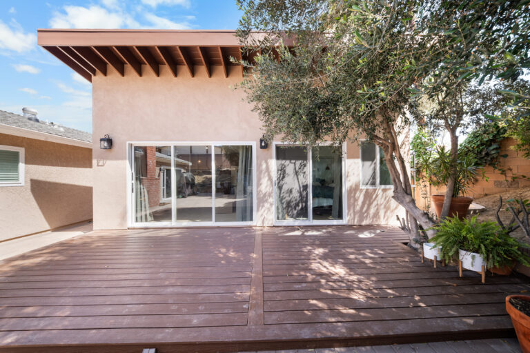 ADU Rear Elevation with Sliding Doors and Deck with exposed beams, sliding glass doors and a dark wood deck in Simi Valley by RnD Builders Inc