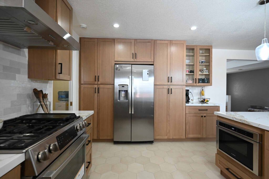 Kitchen remodel with natural wood shaker cabinets, stainless steel appliances, and hexagon tile floor in Simi Valley by RnD Builders Inc
