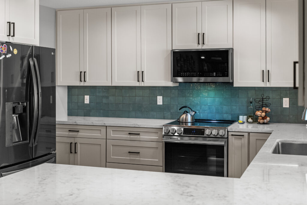 Peninsula Countertop with Teal Backsplash in Thousand Oaks Peninsula Countertop with Teal Backsplash with a white countertop with soft gray veining in Thousand Oaks by RnD Builders Inc