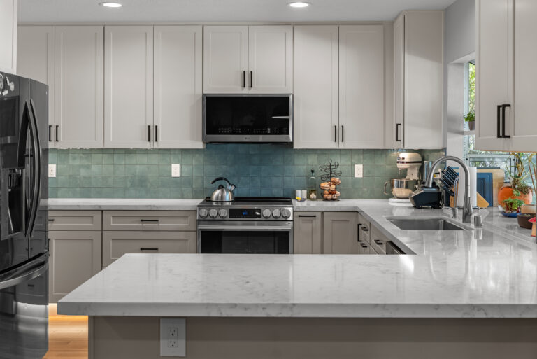 Peninsula and Refrigerator Wall with White Upper Cabinets with a peninsula countertop in Thousand Oaks by RnD Builders Inc