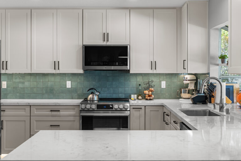 Thousand Oaks kitchen remodel: Gray Lower Cabinets, White Uppers and Teal Backsplash in Thousand Oaks by RnD Builders Inc
