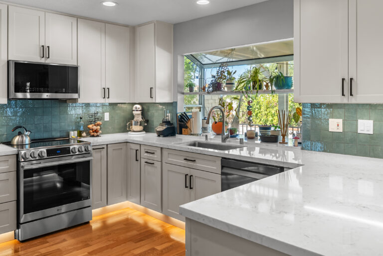 Corner View with Hardwood Floor and Toe-Kick Lighting with a stainless range in Thousand Oaks by RnD Builders Inc