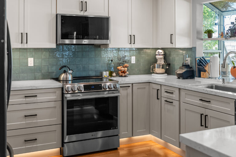 Range and Drawer Cabinets with Toe-Kick Lighting with a stainless range in Thousand Oaks by RnD Builders Inc